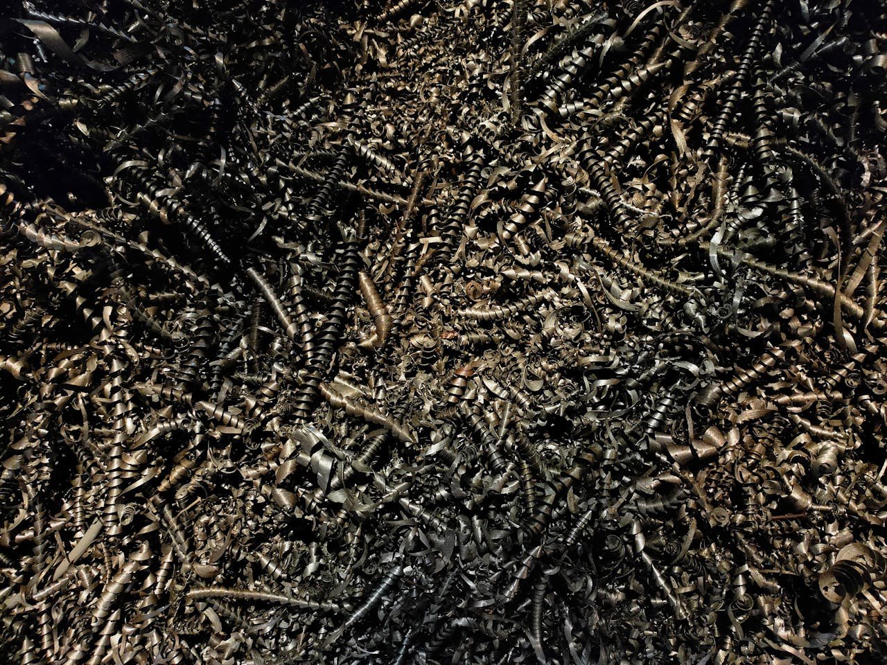 Detailed close-up of a heap of twisted metal shavings, showcasing a complex texture.